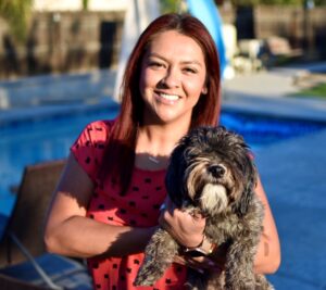 Ivy Ruiz holds her dog and smiles