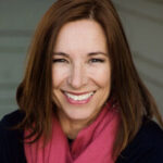 Headshot of Dr. Sara Pizano smiling and wearing a magenta scarf and dark overcoat